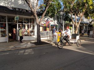 Pedi-cab drivers slowly make their way along the historic quarter