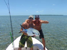 Anglers show off the permit they caught, and released, on the flats