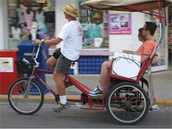 Pedi-cab riding down Duval Street