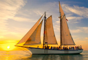 Schooner Appledore with a group watching the sun set over the ocean in Key West