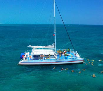 Big sailing cat at anchor with snorkelers around the boat