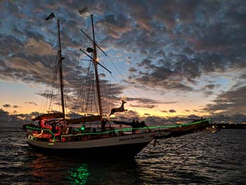 Sunset sailing boat returning to Key West harbor