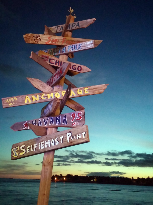 Sign post on the pier of the Ocean Key House at the end of Duval Street, Key West