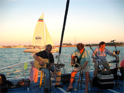 Musicians performing on the bow of the ship during sunset sail