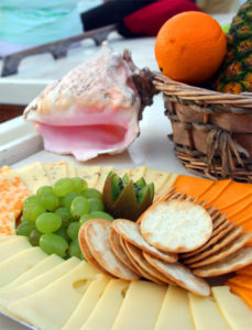 Assortment of snacks, including crackers, cheese, and fruit